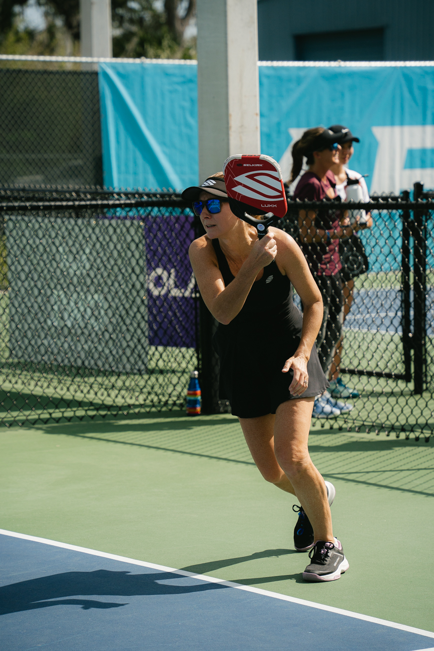 Heather Lovett moving to the ball during a competitive pickleball point
